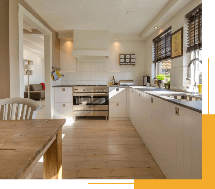 A Kitchen With a Wooden Table and White Cabinets