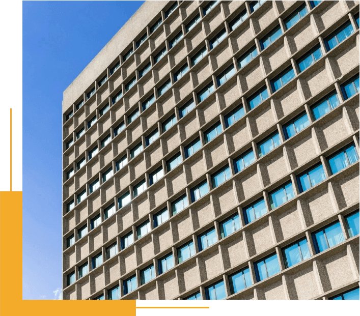 A Tall Building With Lots of Windows Next to a Blue Sky